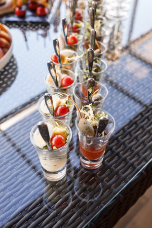Buffet table for guests at a banquet with various snacks and sandwichesの写真素材