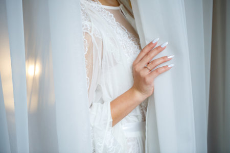Beautiful bride in a white coat on a wedding dayの写真素材