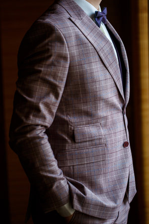 Man puts on a wedding suit and accessories on the wedding day.の写真素材