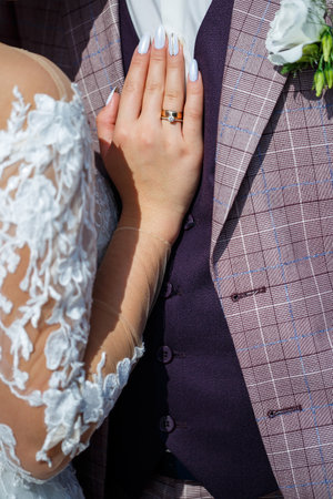 Bride and groom hugging on a wedding dayの写真素材