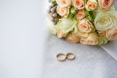gold wedding rings on the wedding day for the newlyweds. Jewelry from expensive metalの写真素材