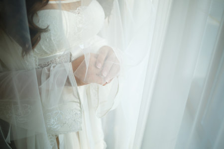 Beautiful bride in a white coat on a wedding dayの写真素材