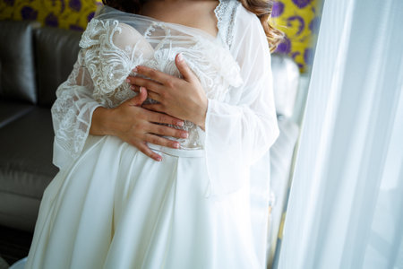 the bride holds in her hands a beautiful wedding dressの写真素材
