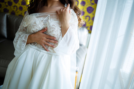 the bride holds in her hands a beautiful wedding dressの写真素材