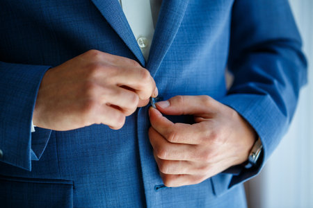 man puts on a suit on the wedding dayの写真素材