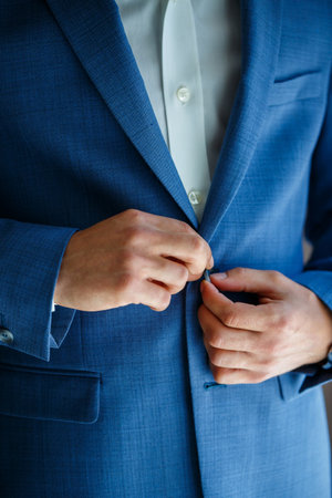 man puts on a suit on the wedding dayの写真素材