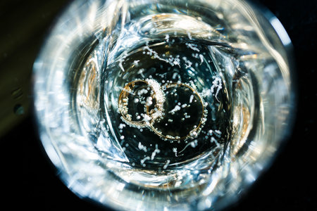 Champagne glasses with engagement Jewelry in front of autumn backgroundの写真素材