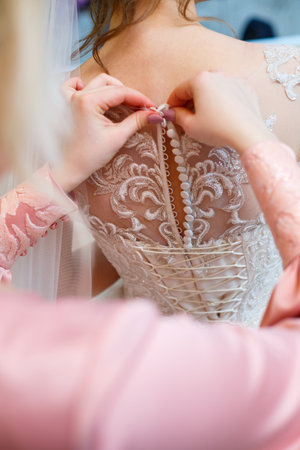 the bride holds in her hands a beautiful wedding dressの写真素材