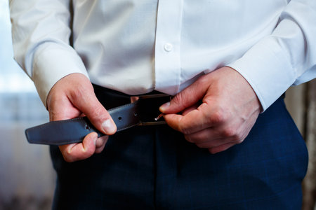 A man puts on a men's suit on the day of the weddingの写真素材