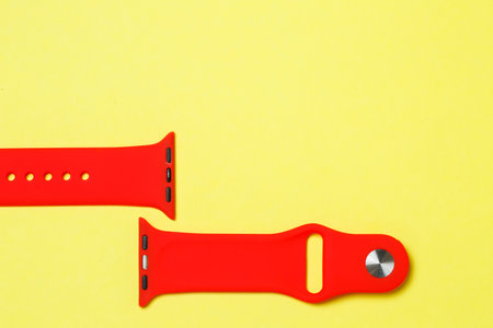 silikone strap for smart watch red color on yelow backgroundの写真素材