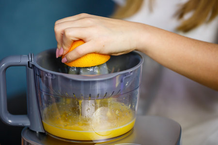 Little girl squeezed fresh juice from fruits of apples and orange. Vitamins and healthy nutrition for children.の写真素材