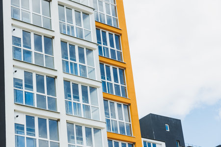 New modern multi-storey residential building. Plastic windows in a new apartment. Apartment with a...