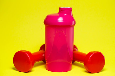 red dumbbells, pink shaker, colored background, sports, energy drink, gym equipmentの写真素材