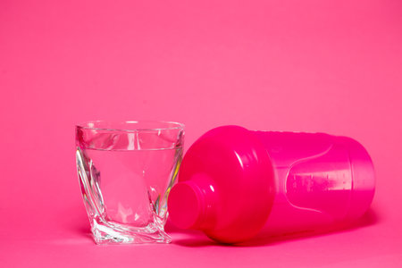 pink shaker, glass of water, colored background, sports, energy drink, gym equipmentの写真素材