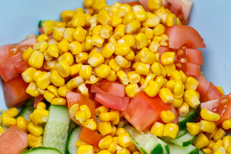 Corn salad, tomato and cucumber with olive oil. Food is proper nutrition. Vegetarian foodの写真素材