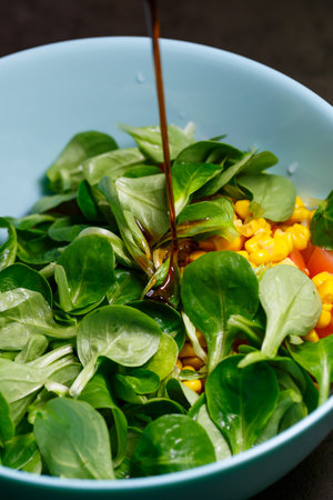 Spinach, corn, tomato and cucumber salad with olive oil. Food is proper nutrition. Vegetarian foodの写真素材