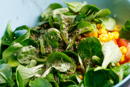 Spinach, corn, tomato and cucumber salad with olive oil. Food is proper nutrition. Vegetarian foodの写真素材