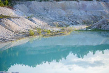 Aerial spectacular view to scenic valley with beautiful mountain lake, conifer forest and rocky...