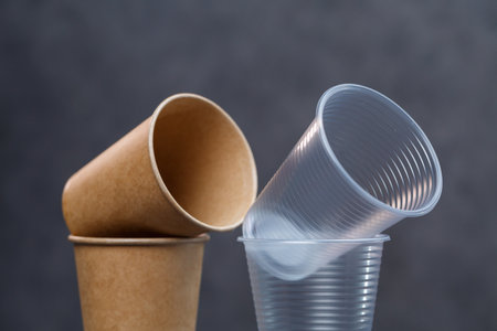 Eco-friendly disposable tableware made of bamboo wood and paper on a gray background. Plastic dishes and cutlery. Caring for the environment. Recycling problem. safe planet, environmental concept.の写真素材