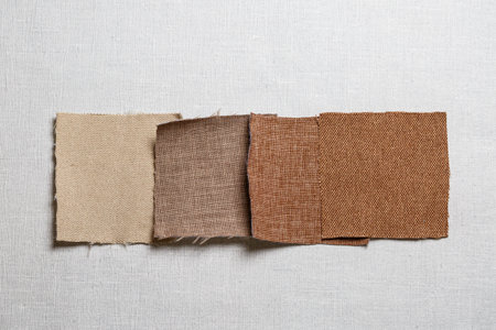 square pieces of multi-colored fabric laid out on a gray backgroundの写真素材