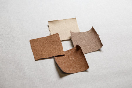 square pieces of multi-colored fabric laid out on a gray backgroundの写真素材