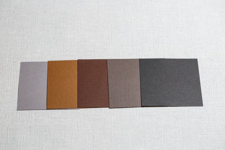 square pieces of multi-colored fabric laid out on a gray background