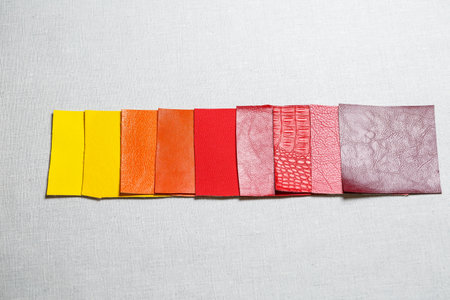 square pieces of multi-colored fabric laid out on a gray backgroundの写真素材