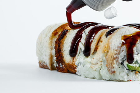 Japanese food sushi rolls with eel and cream cheese topped with unagi sauceの写真素材