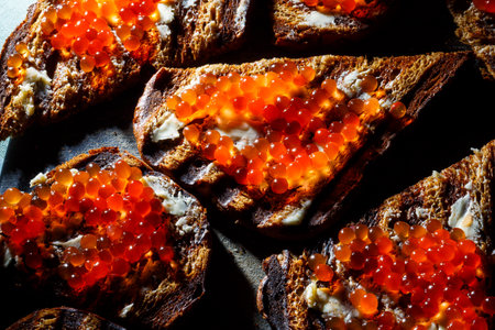 rye bread toast with butter and red salmon caviarの写真素材