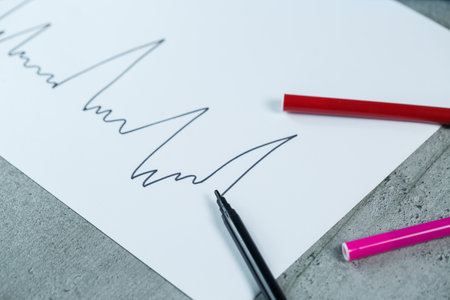 many multi-colored markers for drawing with drawings on white paperの写真素材