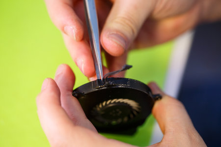 man cleans a laptop with a special tool from dust. Repair and maintenance of laptops and PCs...