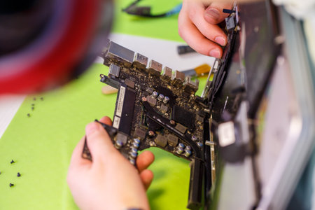 Professional computer and tablet repair shop or service. Close up of a computer board. Electronics concept. Detail from a laptop under repairの写真素材