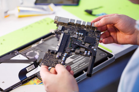 Professional computer and tablet repair shop or service. Close up of a computer board. Electronics...
