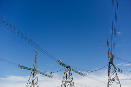 Power lines and high-voltage lines against the backdrop on a sky a summer day. Green energy....