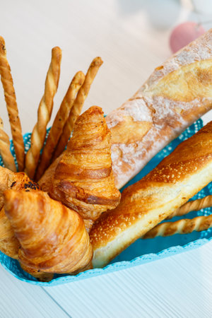 A basket with fresh pastries, croissants and bread. Whole grain baked goods, yeast-free breadの写真素材
