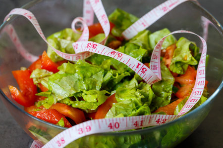 chopped fresh vegetable salad in a plate for a vegetarian girlの写真素材