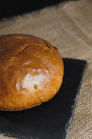 Delicious fresh rye round bread on a dark background. Crispy fresh bread. Freshly baked bread