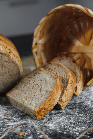 Slices of whole grain rye fresh bread on a dark background close up. Fresh home-baked sourdough...