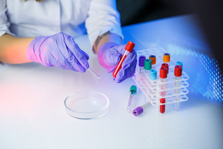 A medical professional, laboratory assistant, doctor performs an analysis in a laboratory, uses test...
