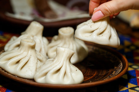 Georgian national dish Khinkali. Laid on a clay plateの写真素材