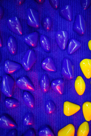Colored stones glued to a blue clothの写真素材