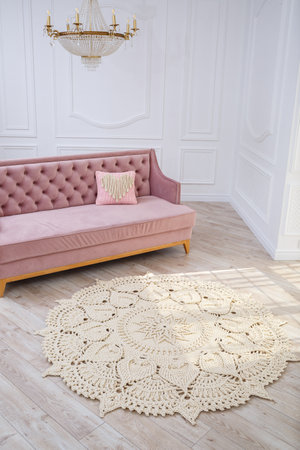 Handmade carpet knitted from natural threads, flooring, natural cotton. Beige handmade carpet. Interior solution for a house or apartmentの写真素材