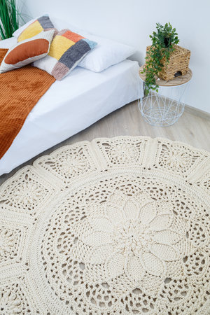 Cute homemade thick thread knitting pattern made by hand: handmade beige thread rug, woven pattern, rustic traditions, knitting artの写真素材