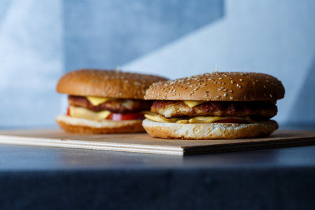Large juicy burger with cutlet cheese and tomatoes. Fast foodの写真素材