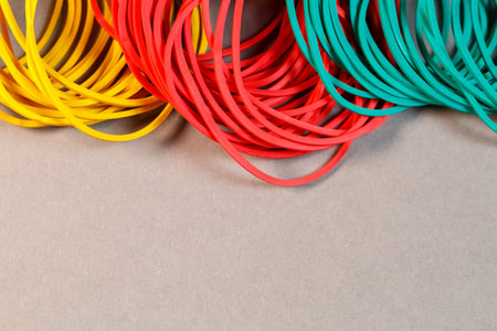 Colored rubber bands for money on a colored background. Stationery accessoriesの写真素材