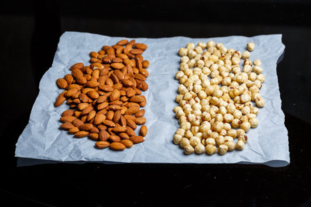 Roasted delicious nuts almonds and hazelnuts on a white background.の写真素材
