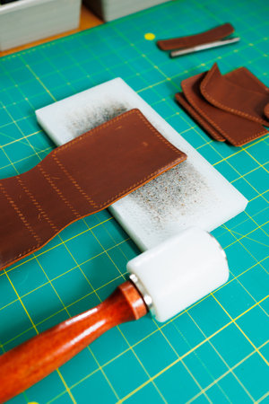 Tools for making leather goods and pieces of brown leather. Production of leather products. View...