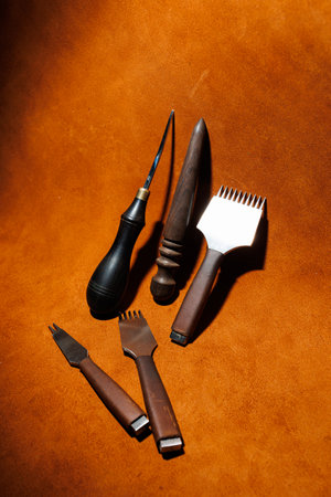 Production of handicrafts from genuine leather. Tools for making leather goods and pieces of brown...