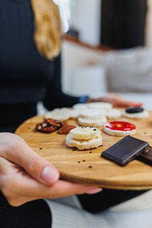 Female hands with bread. Delicious dry breakfasts. Fitness bread for a quick snack. Rice cakesの写真素材