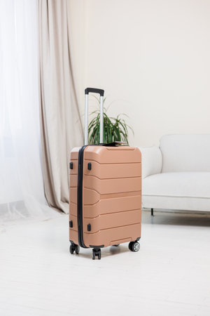 Pink plastic strong suitcase for carrying luggage on a white background. A bright suitcase for travelの写真素材